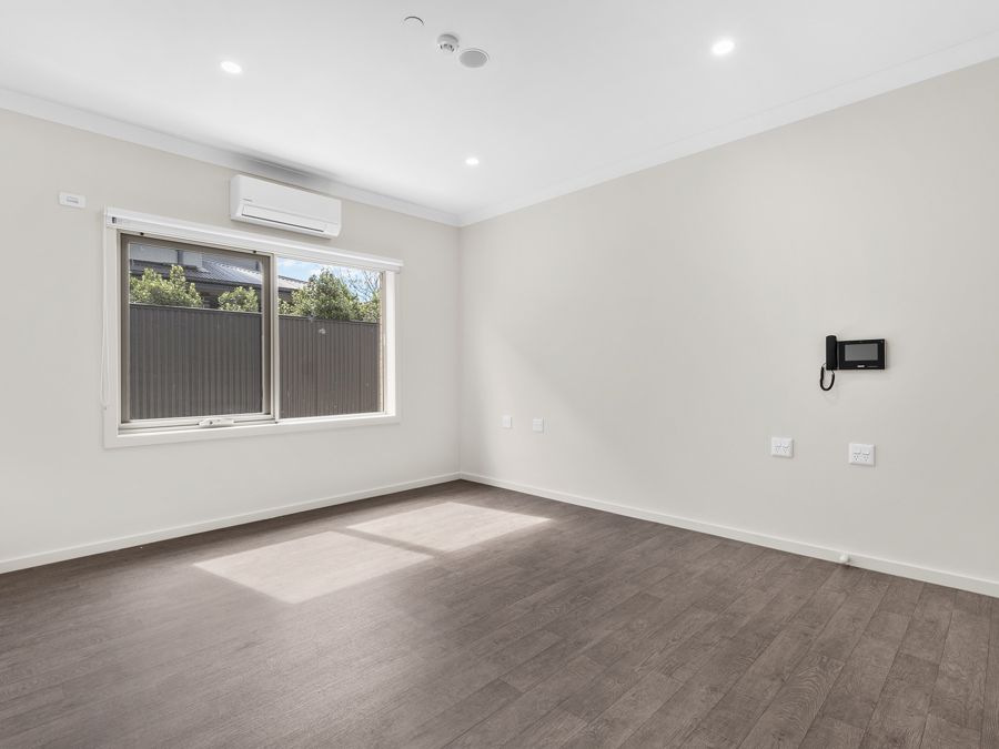 A bedroom with built-in robe and garden window