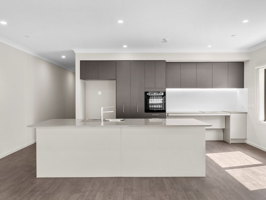 Kitchen with island bench and accessible appliances